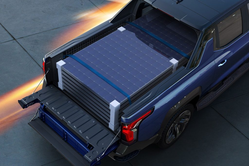 Image of a blue Chevrolet Silverado EV truck bed with solar panels at night 